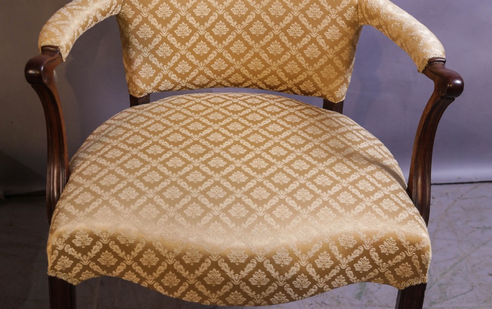 A pair of Georgian period mahogany armchairs upholstered in gold pattern damask fabric with swept timber arms. View VII
