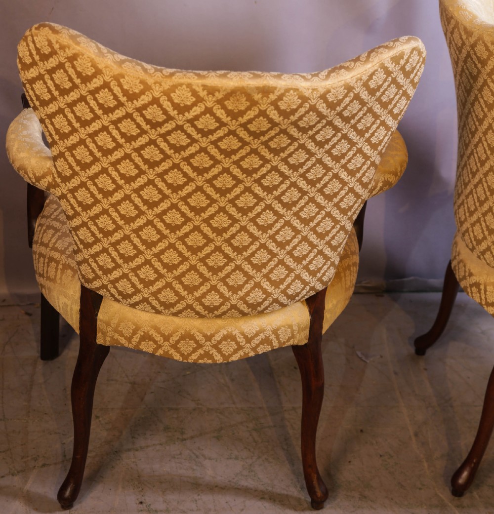 A pair of Georgian period mahogany armchairs upholstered in gold pattern damask fabric with swept timber arms. View XII