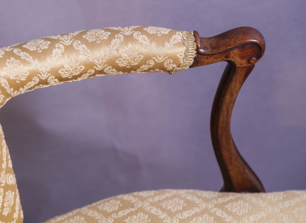 A pair of Georgian period mahogany armchairs upholstered in gold pattern damask fabric with swept timber arms. View XIV
