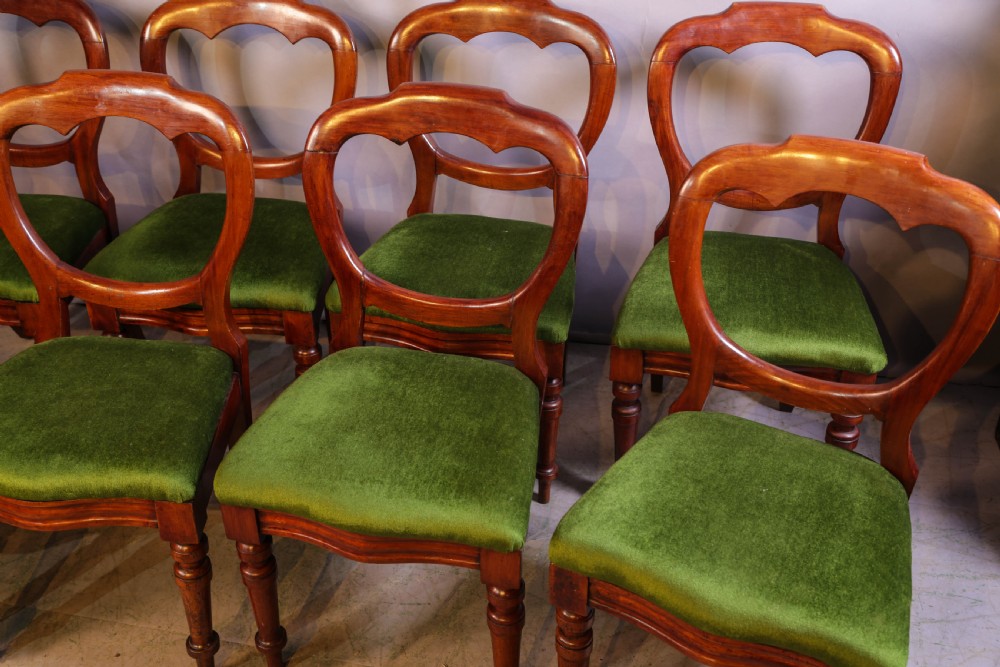 A set of eight Victorian mahogany balloon-back dining chairs with green velvet upholstered seats and turned front legs. View III