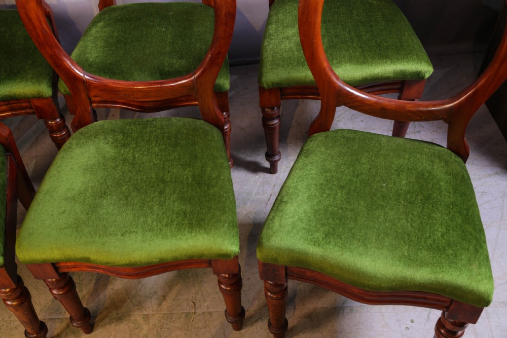 A set of eight Victorian mahogany balloon-back dining chairs with green velvet upholstered seats and turned front legs. View IV