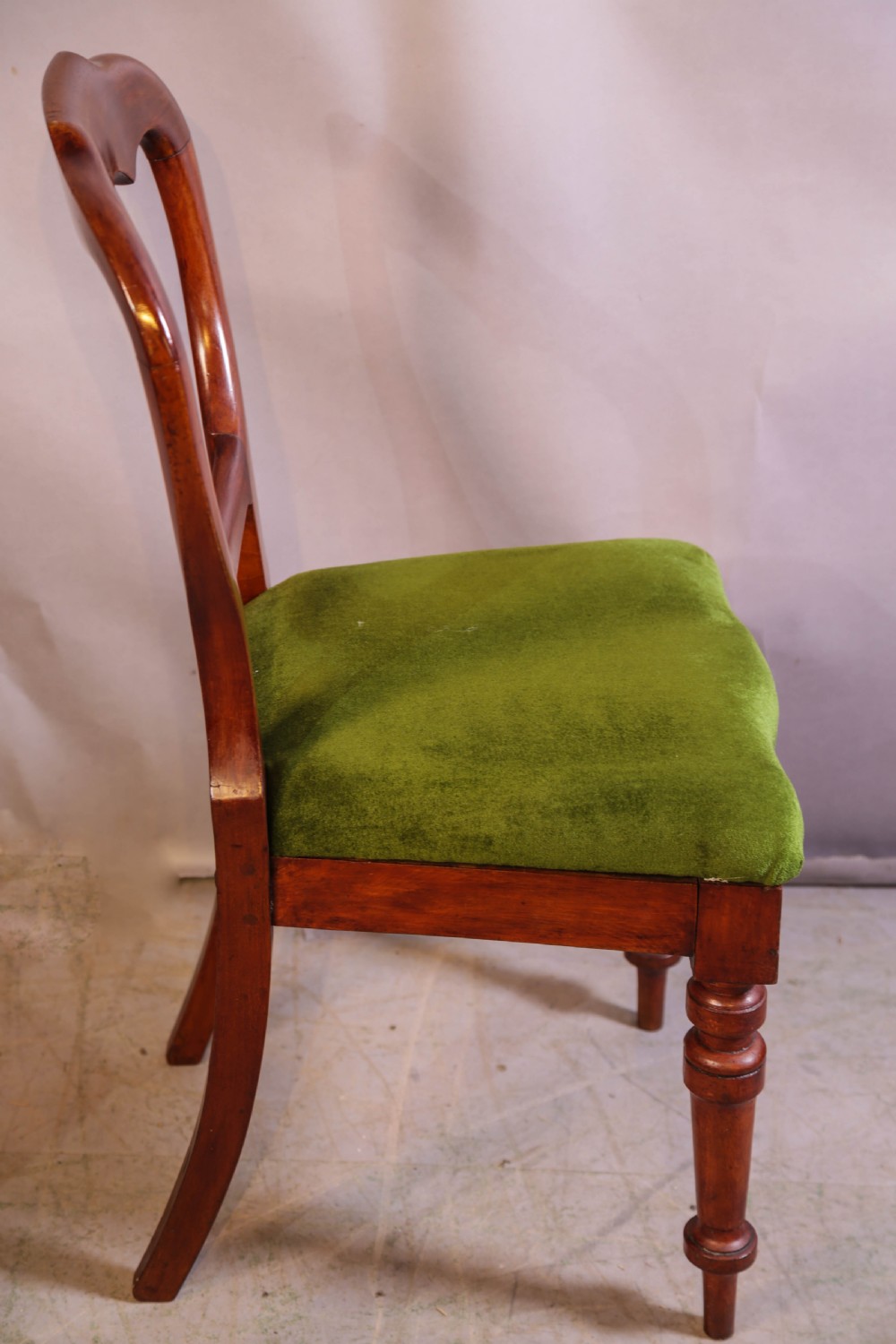 A set of eight Victorian mahogany balloon-back dining chairs with green velvet upholstered seats and turned front legs. View IX