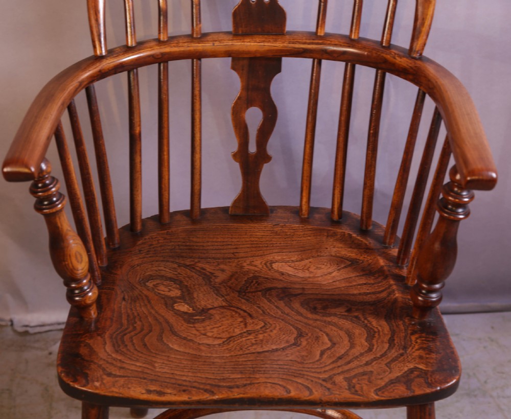A wooden Windsor armchair featuring a steam-bent hoop back, pierced central splat, shaped elm seat, and turned legs. View II