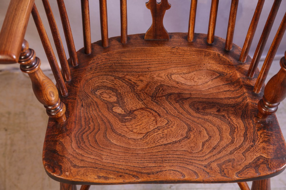 A wooden Windsor armchair featuring a steam-bent hoop back, pierced central splat, shaped elm seat, and turned legs. View VI