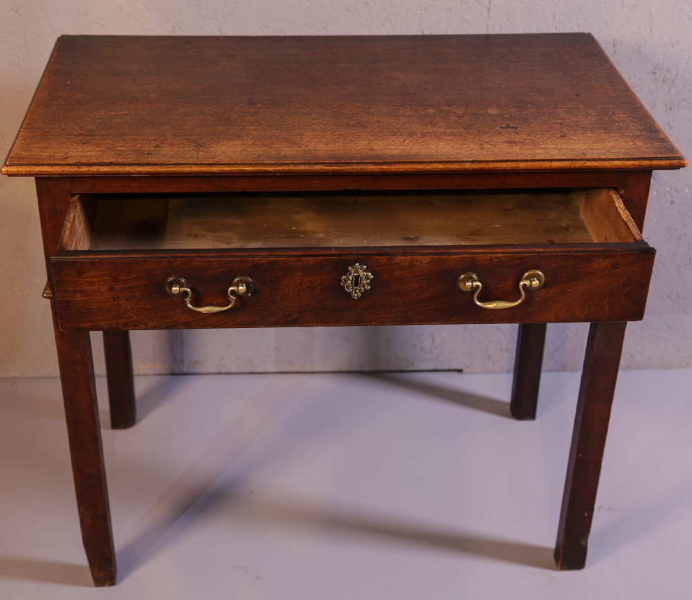 A dark Georgian mahogany side table featuring a single drawer with brass swan neck handles and square legs. View III