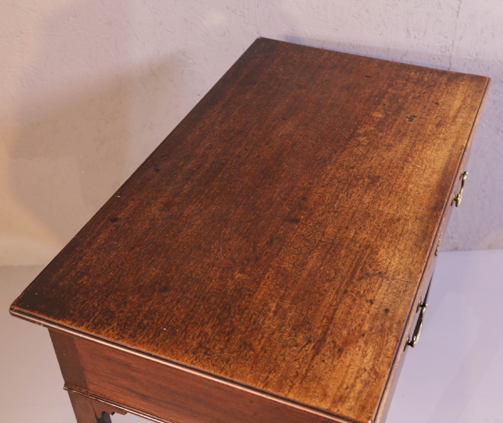 A dark Georgian mahogany side table featuring a single drawer with brass swan neck handles and square legs. View V