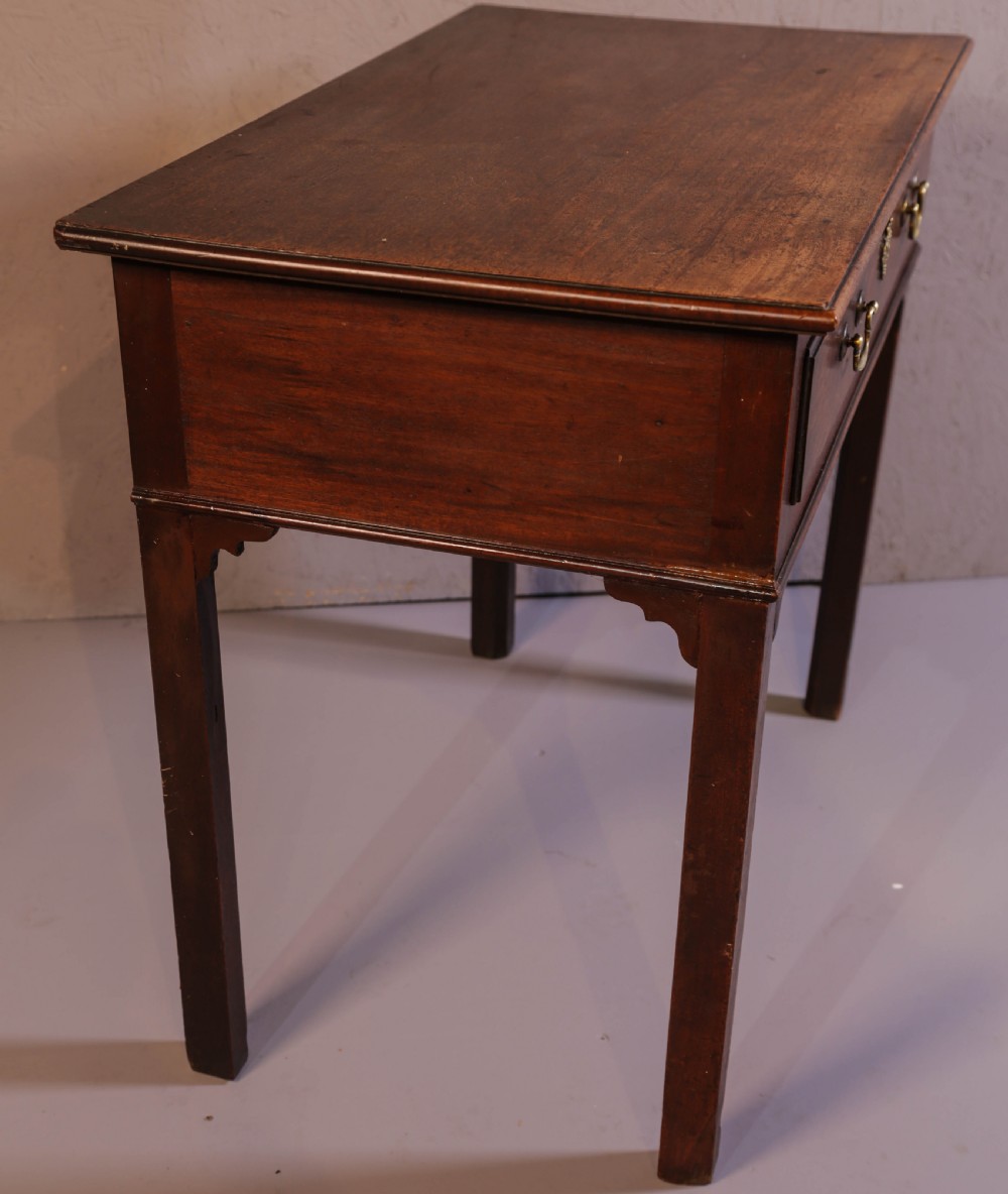 A dark Georgian mahogany side table featuring a single drawer with brass swan neck handles and square legs. View VII