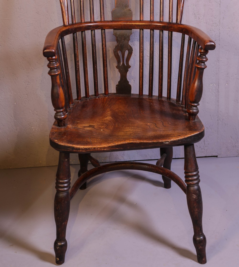 A high-back wooden Windsor armchair featuring a steam-bent hoop frame, a central pierced splat, turned legs, and a contoured elm saddle seat. View II