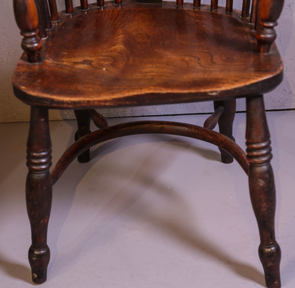 A high-back wooden Windsor armchair featuring a steam-bent hoop frame, a central pierced splat, turned legs, and a contoured elm saddle seat. View IV