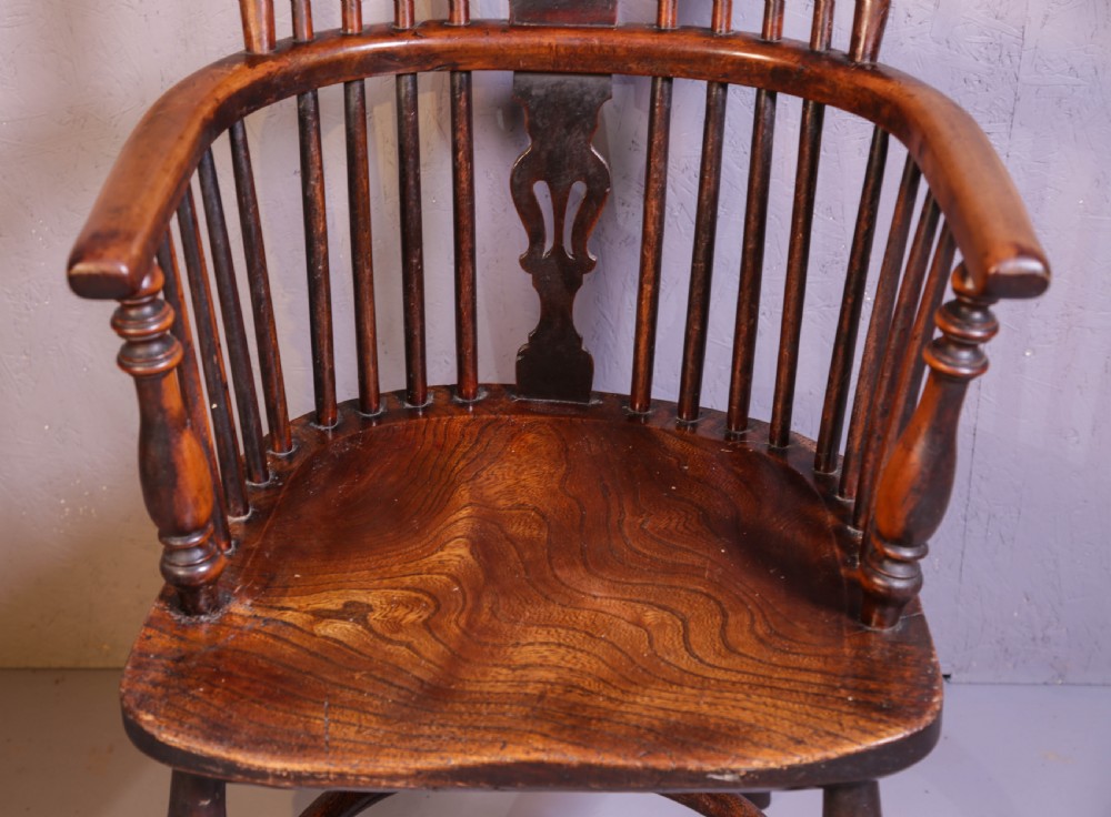 A high-back wooden Windsor armchair featuring a steam-bent hoop frame, a central pierced splat, turned legs, and a contoured elm saddle seat. View VI