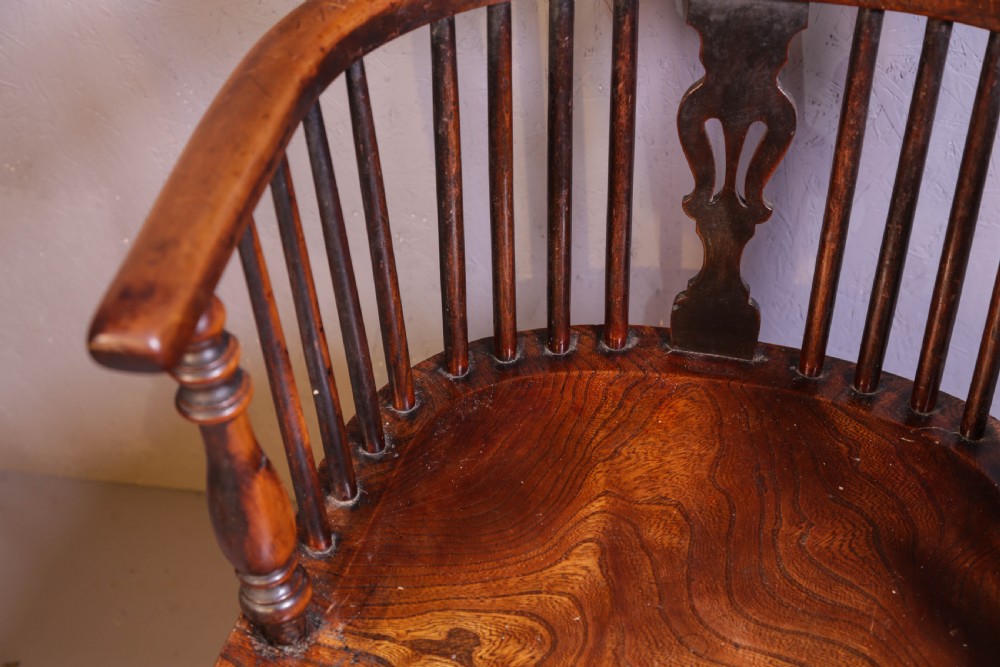 A high-back wooden Windsor armchair featuring a steam-bent hoop frame, a central pierced splat, turned legs, and a contoured elm saddle seat. View VII