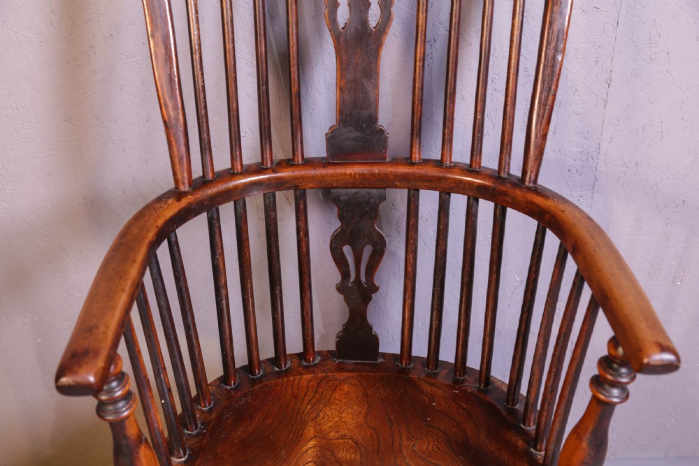 A high-back wooden Windsor armchair featuring a steam-bent hoop frame, a central pierced splat, turned legs, and a contoured elm saddle seat. View IX