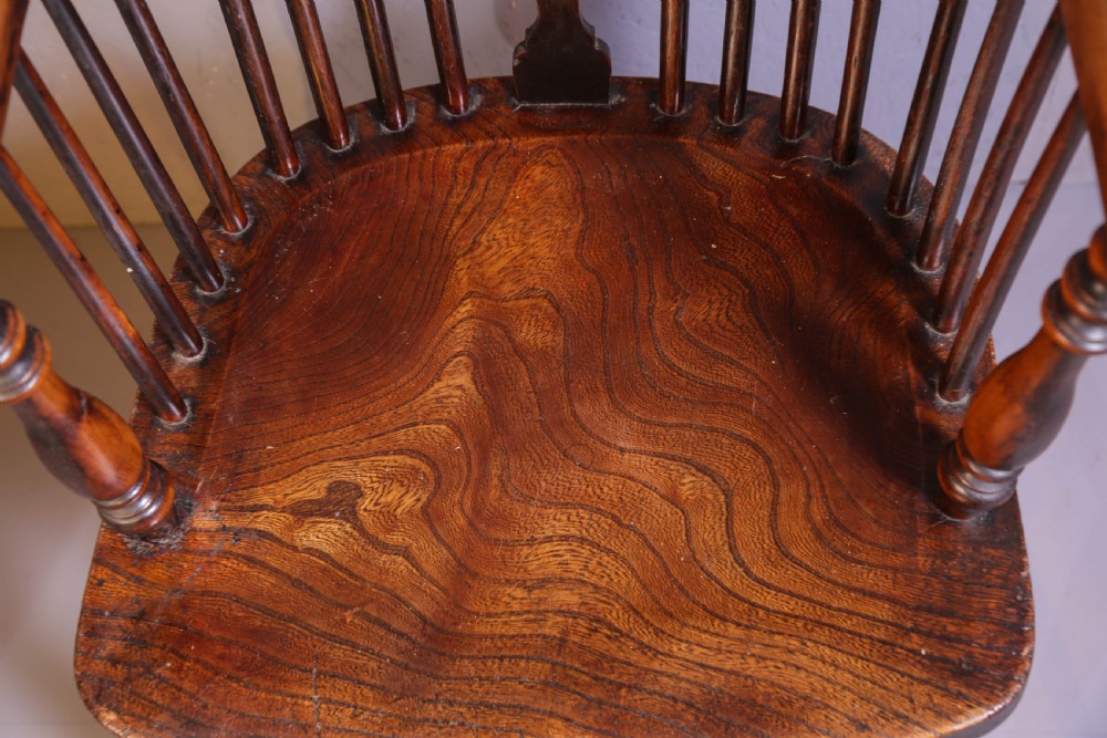 A high-back wooden Windsor armchair featuring a steam-bent hoop frame, a central pierced splat, turned legs, and a contoured elm saddle seat. View XI