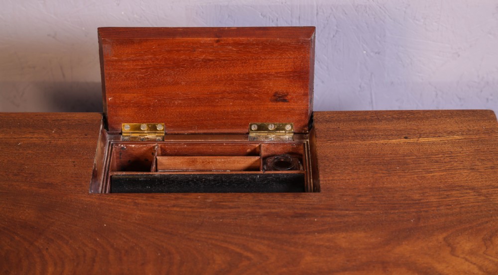 An antique mahogany library table featuring turned reeded legs with brass castors, a single frieze drawer with turned wooden handles, and a rectangular top. View IV