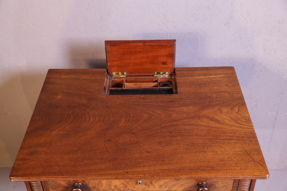An antique mahogany library table featuring turned reeded legs with brass castors, a single frieze drawer with turned wooden handles, and a rectangular top. View V