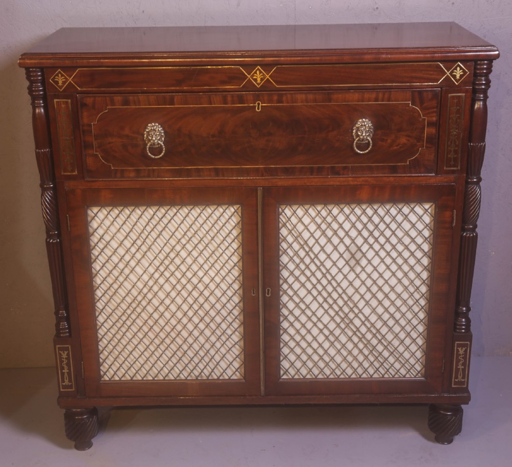 A Regency rosewood chiffonier with brass inlay, a long drawer featuring lion mask handles, and lower double doors with brass wire grilles over fabric.