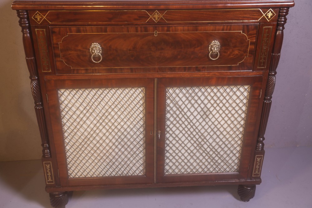 A Regency rosewood chiffonier with brass inlay, a long drawer featuring lion mask handles, and lower double doors with brass wire grilles over fabric. View XIII