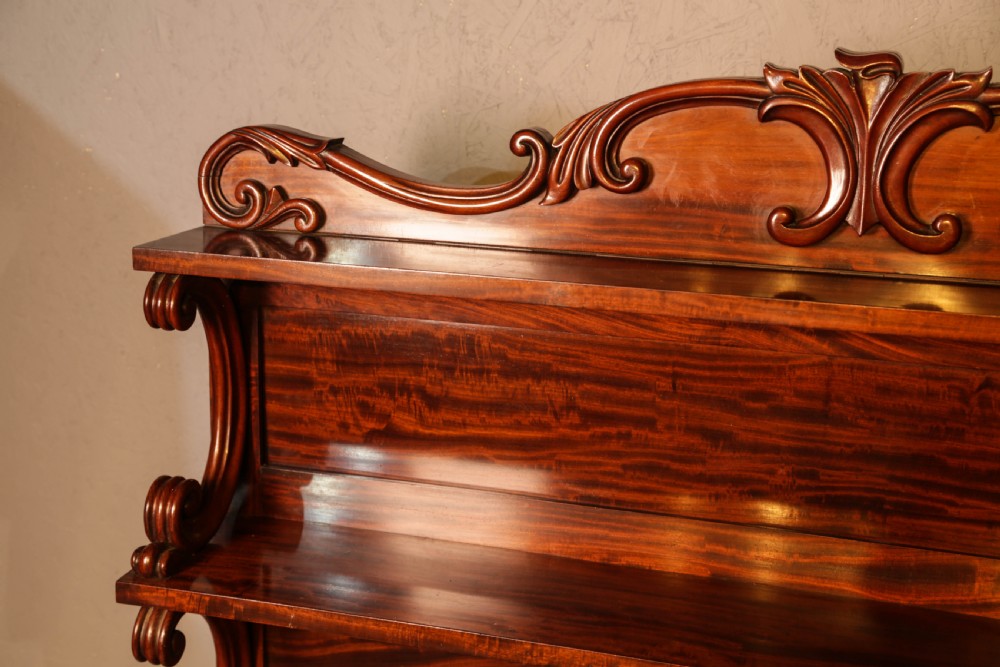 A three-tier Victorian mahogany wall shelf featuring an ornate carved cresting rail and curved side supports. View III