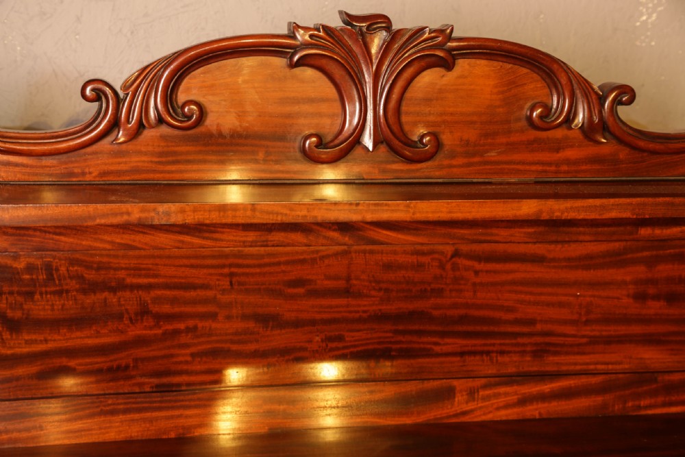 A three-tier Victorian mahogany wall shelf featuring an ornate carved cresting rail and curved side supports. View VII
