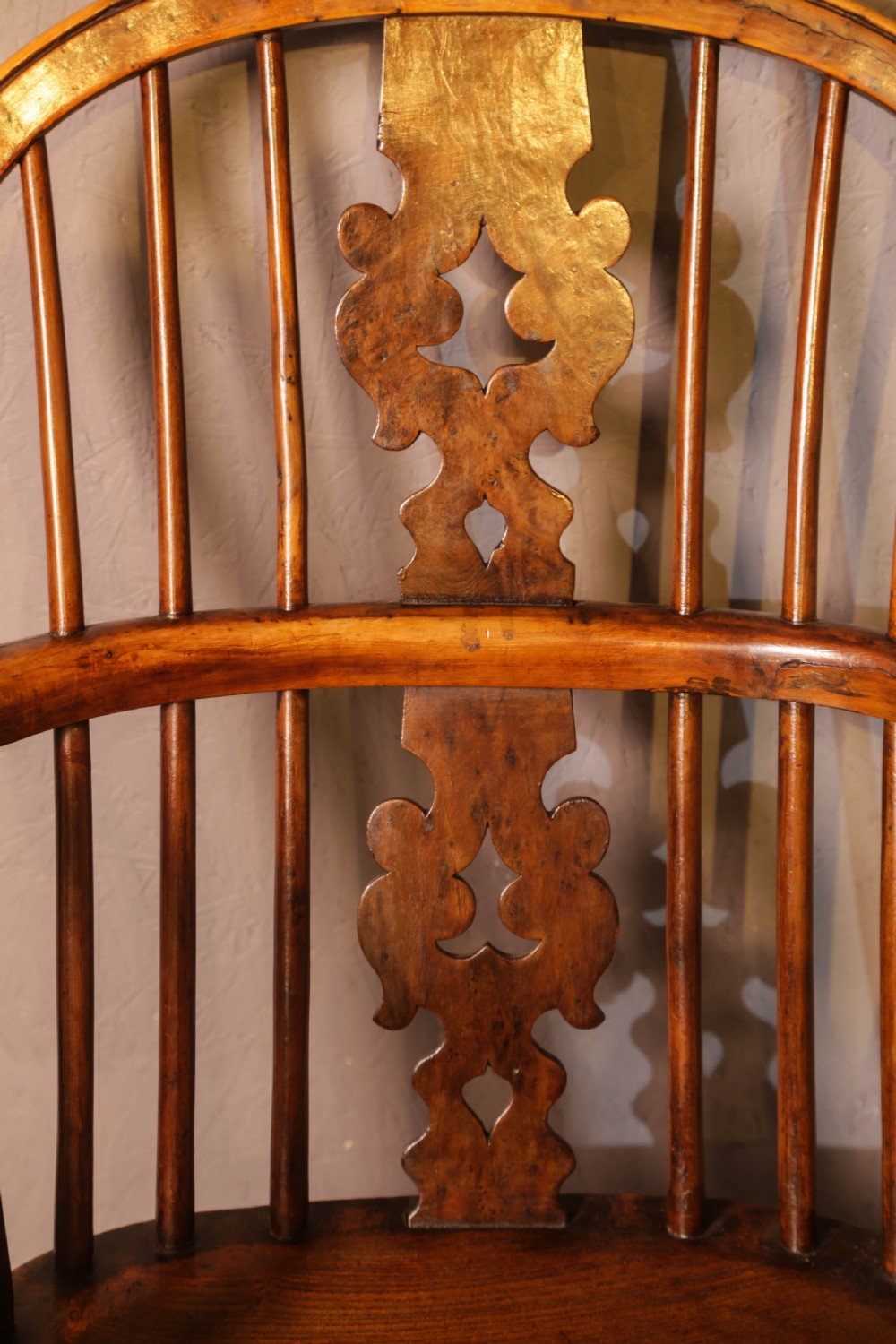 A low-back yew wood Windsor armchair featuring turned legs, a shaped saddle seat, a pierced burr splat, and a curved stretcher. View VI
