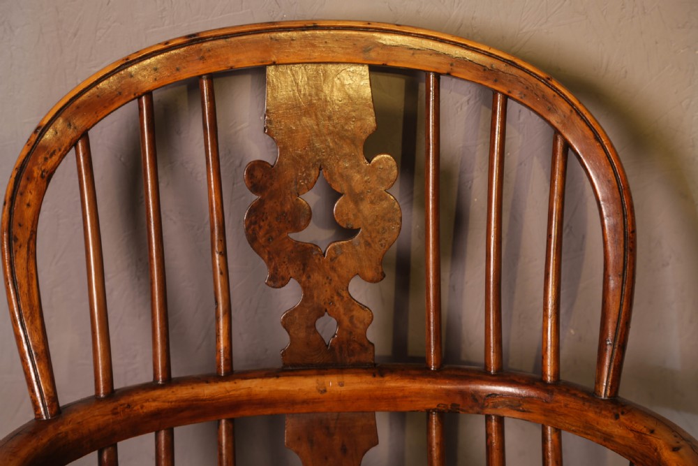 A low-back yew wood Windsor armchair featuring turned legs, a shaped saddle seat, a pierced burr splat, and a curved stretcher. View VII