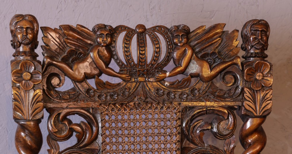 Set of six high-backed Carolean style walnut dining chairs featuring intricate scroll and crown carvings, barley twist pillars, cane back panels, and blue velvet upholstered seats. View VIII
