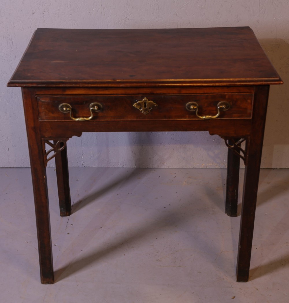 An 18th-century Georgian yew wood side table featuring a single drawer with brass handles, fretwork corner brackets, and straight square legs.