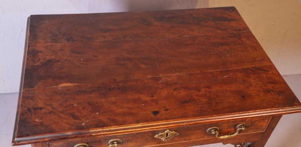 An 18th-century Georgian yew wood side table featuring a single drawer with brass handles, fretwork corner brackets, and straight square legs. View V