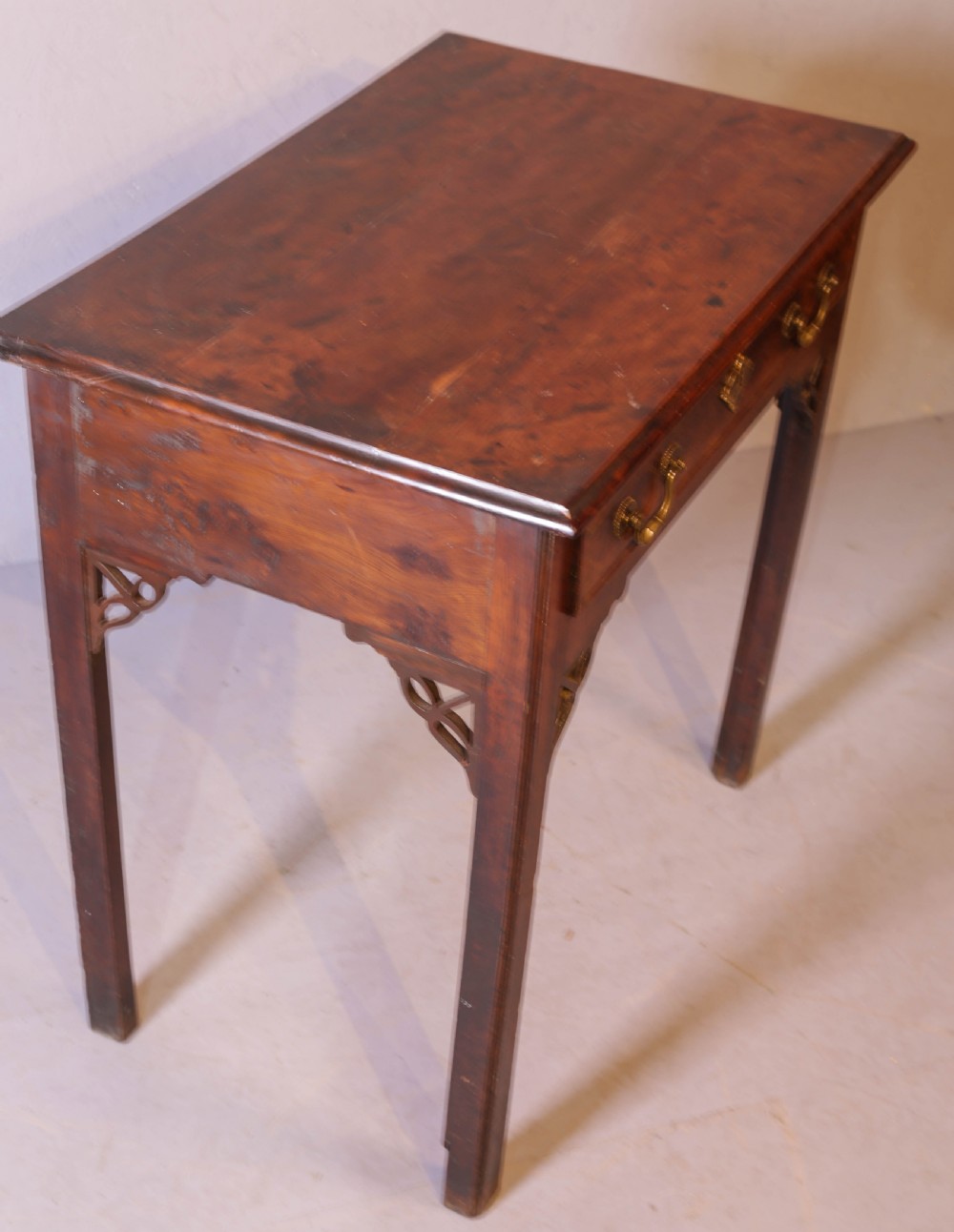 An 18th-century Georgian yew wood side table featuring a single drawer with brass handles, fretwork corner brackets, and straight square legs. View VII
