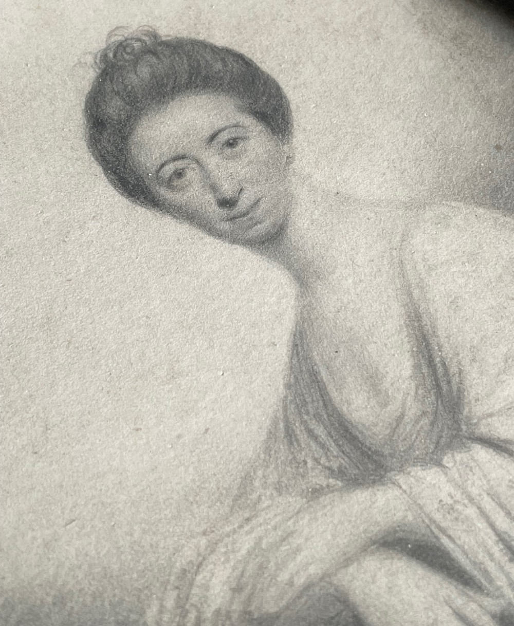 An 18th-century oval monochrome plumbago portrait drawing of a woman, housed in a dark turned wooden frame. View II