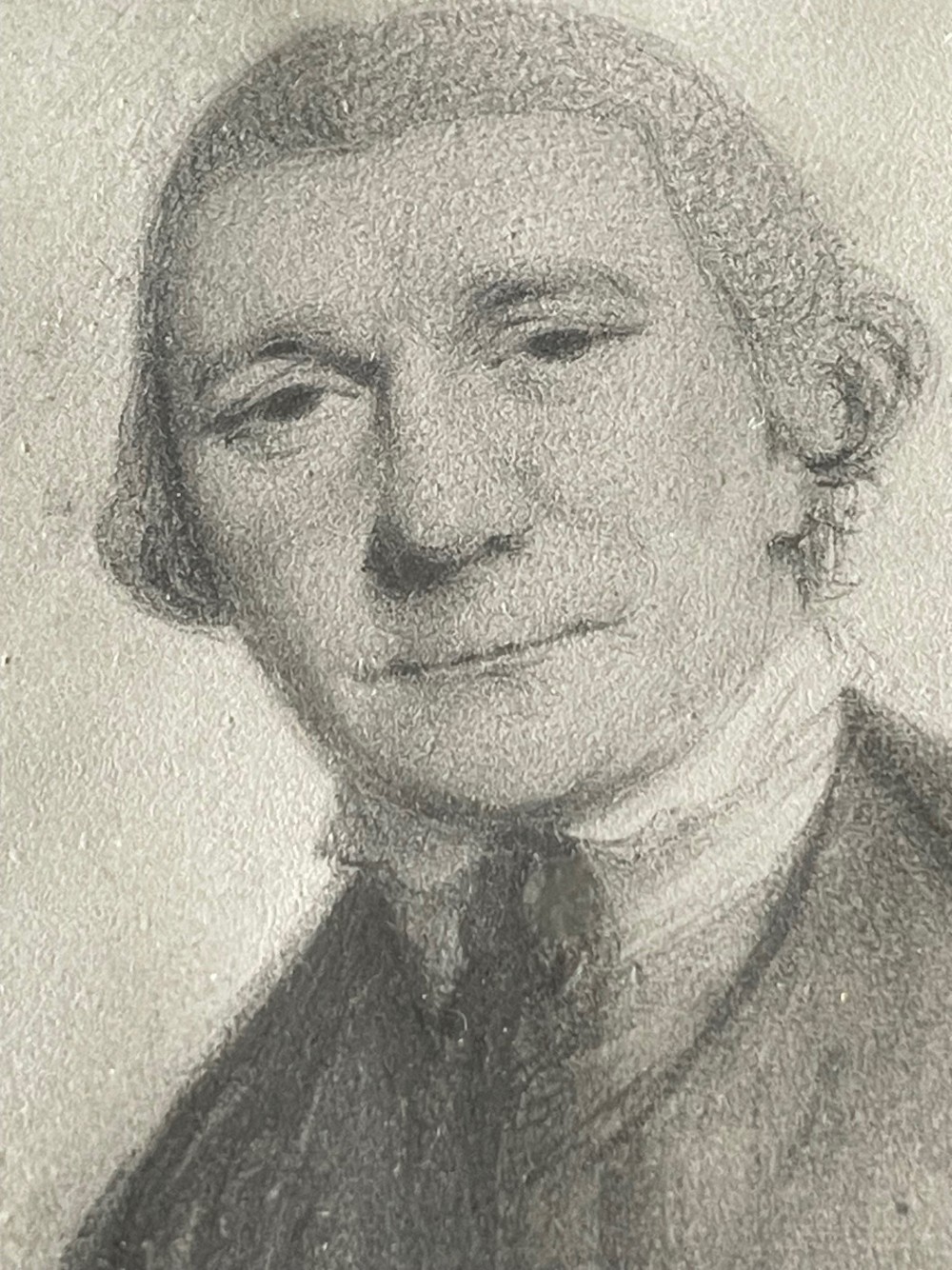 An 18th-century monochrome plumbago drawing depicting a gentleman in an oval molded wooden frame. View II