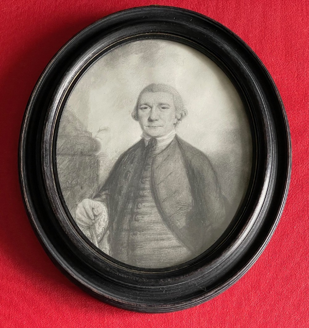 An 18th-century monochrome plumbago drawing depicting a gentleman in an oval molded wooden frame. View IV
