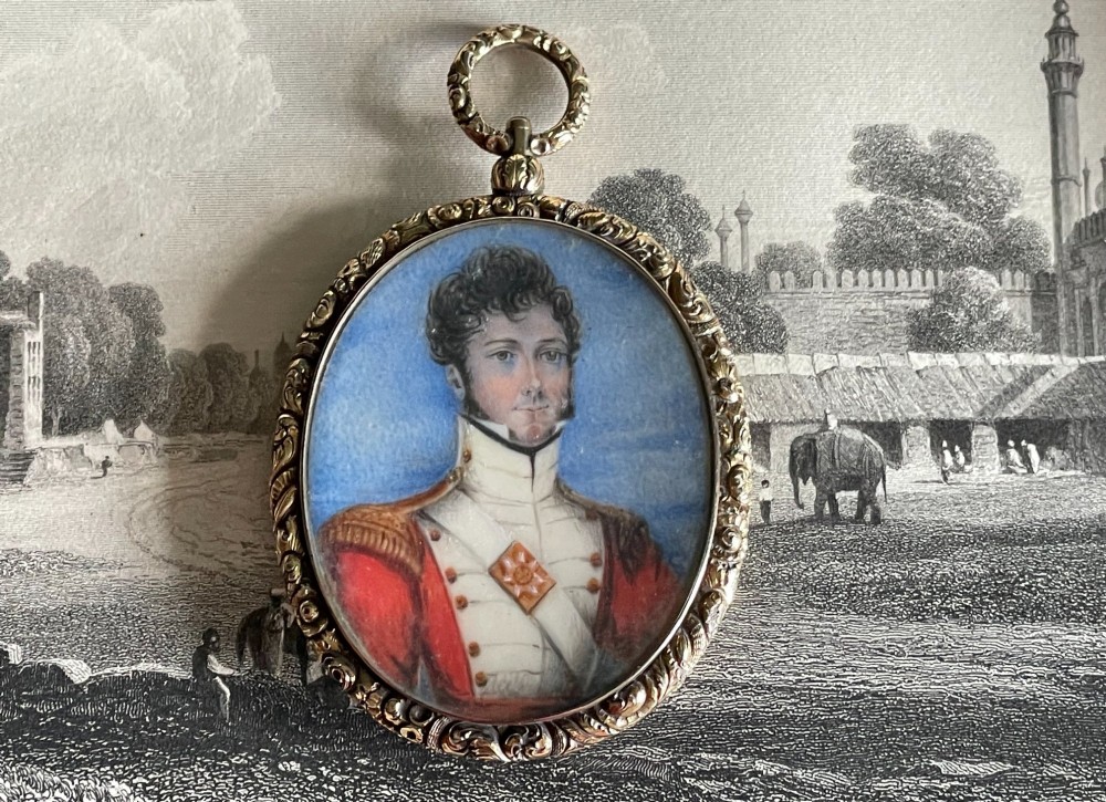 An oval Regency portrait miniature depicting a man in military dress uniform framed in an ornate chased gold-tone pendant casing. View IV