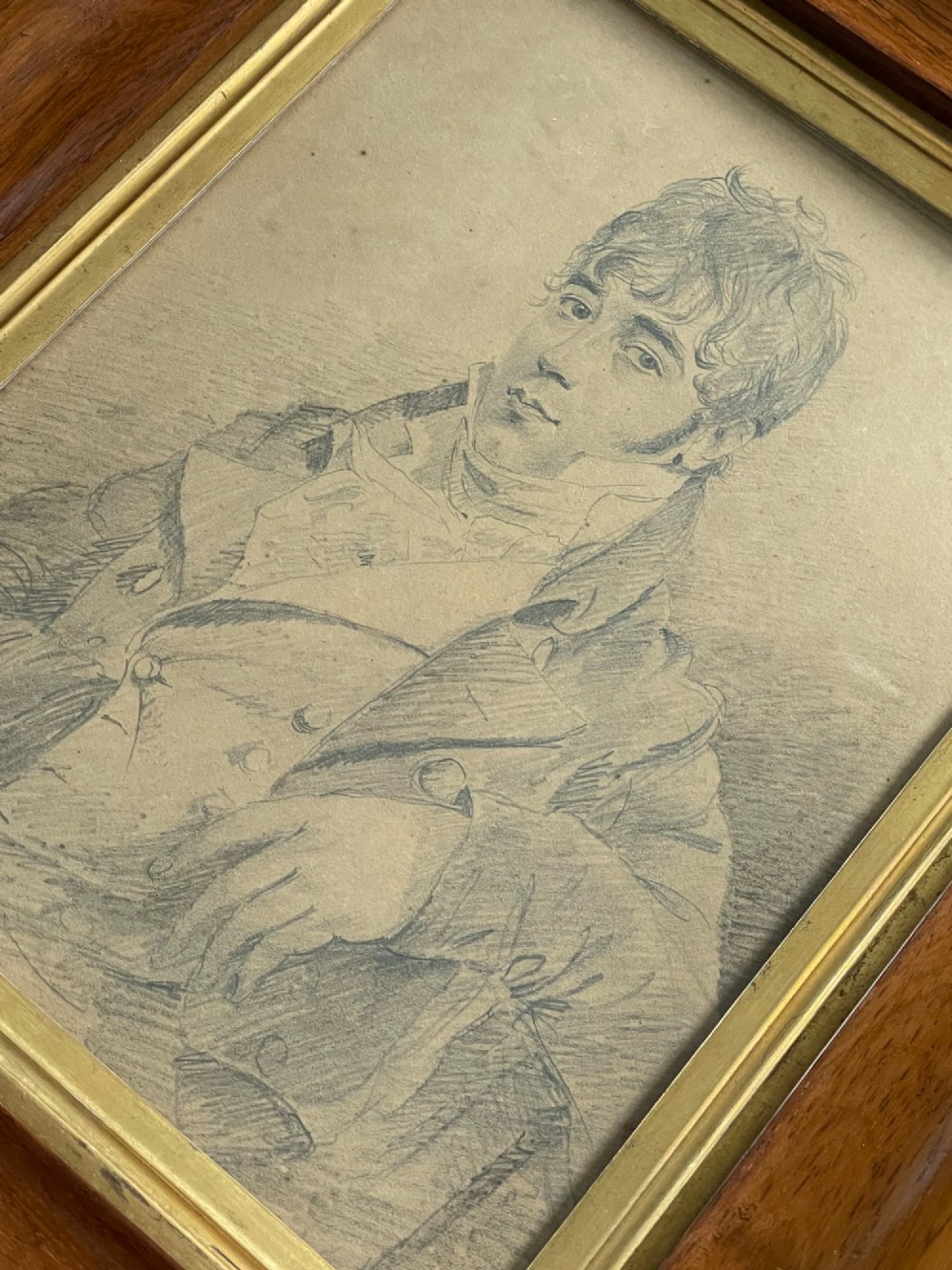 A pair of Regency era graphite portrait drawings framed in wide mahogany mouldings with gilded inner borders. View IV