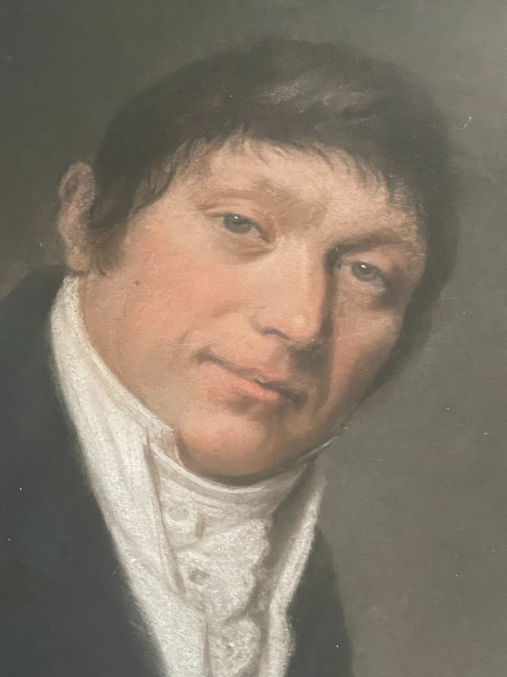 An antique French pastel portrait of a gentleman in a high white cravat and dark coat, set within an ornate gilded wood frame. View II