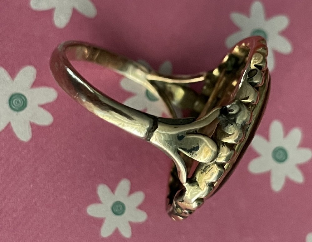 An antique Georgian oval ring featuring a reverse-painted verre eglomise silhouette portrait set within a beaded gold bezel. View III