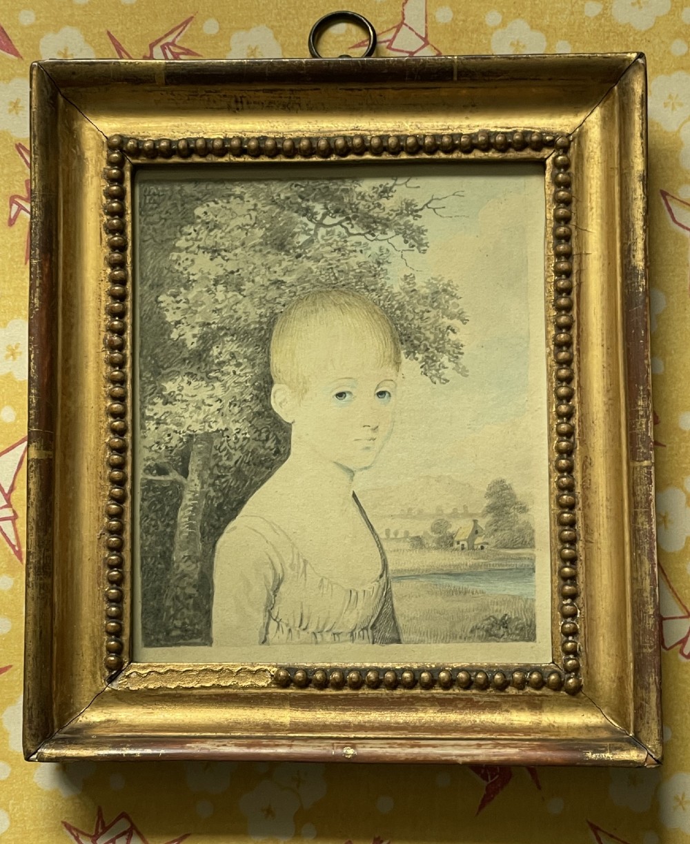 A pair of Georgian watercolour portraits depicting children, framed in matching beaded gilt wood frames with top hanging rings. View II