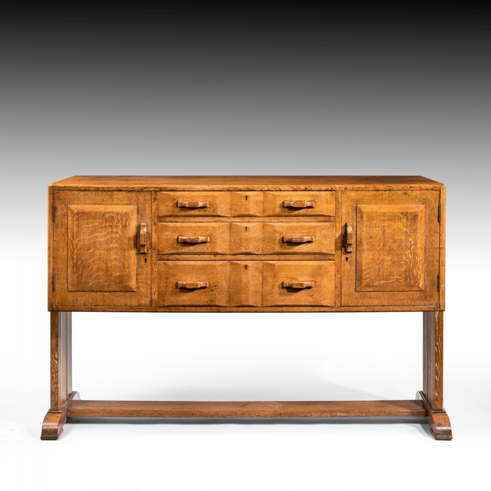 A solid oak early mid-century cabinet by Heals of London
