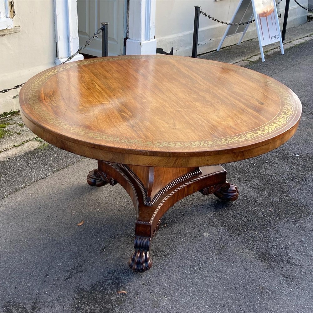 A Regency period rosewood and brass inlaid centre table.