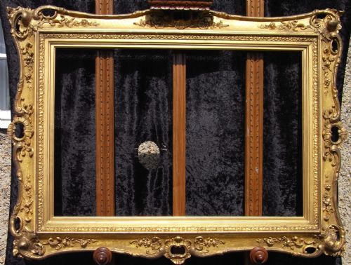 19th Century Victorian 20" X 30" Rococo and Pierced Gilt Reverse Swept Frame/ Mirror with Incised Cross Hatching. Circa 1840