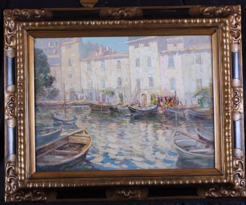 fig 1. An impressionist oil painting depicting small wooden fishing boats moored in a calm French harbour in front of light stone buildings.