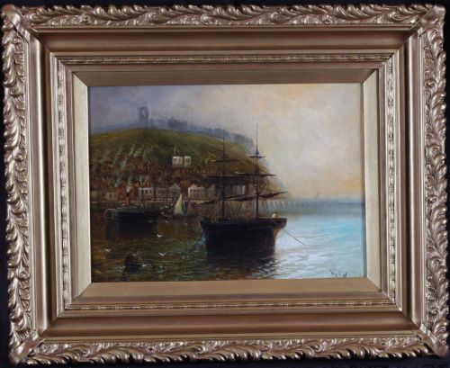 fig 2. A matching pair of framed oil paintings depicting coastal harbour scenes with sailing vessels, set in ornate gold moulding.