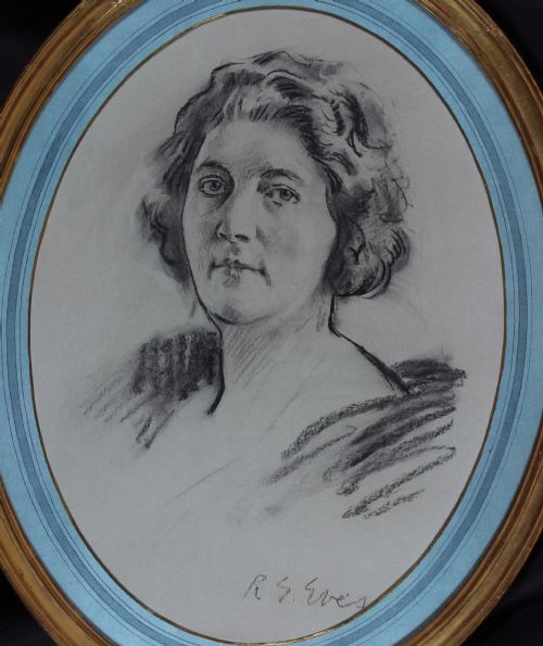fig 1. An oval gilt-framed charcoal portrait drawing of a woman signed by R. G. Eves set against a light blue mount.