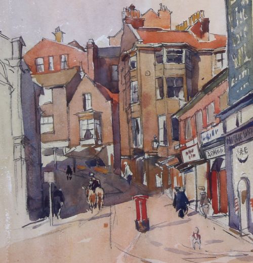 fig 3. A framed 1930 watercolour painting depicting a street scene in Scarborough with architectural buildings and a tall tower under a cloudy sky.