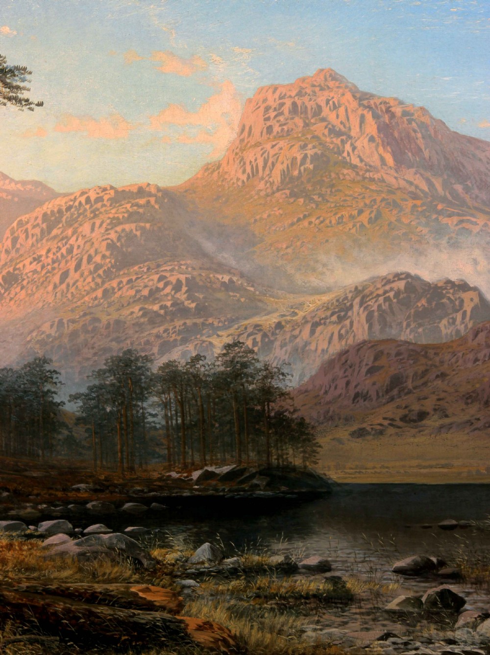 A nineteenth-century oil painting depicting the sunlit pink peaks of the Langdale Pikes overlooking Blea Tarn with tall pine trees and a figure in the foreground. View V