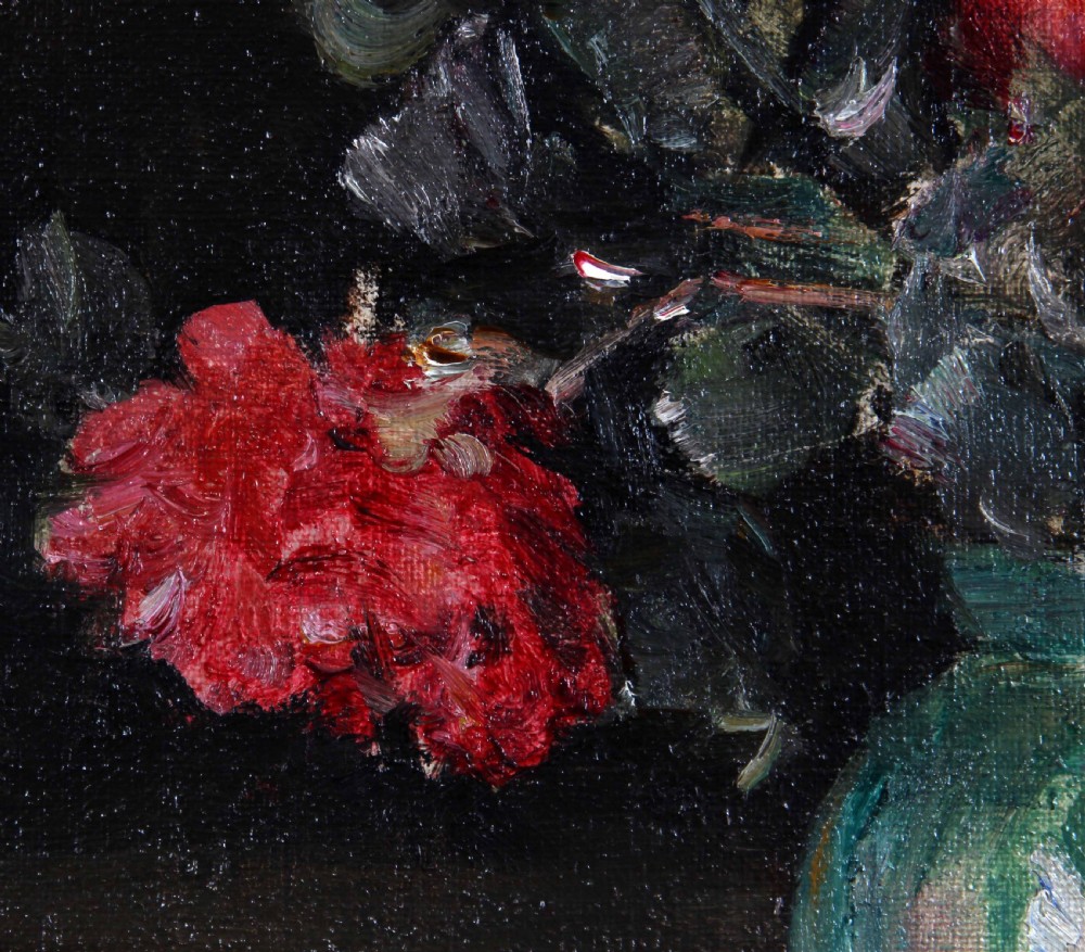 A framed oil painting depicting deep red roses arranged in a green ceramic vase against a dark background, set within an ornate gilt swept frame. View V