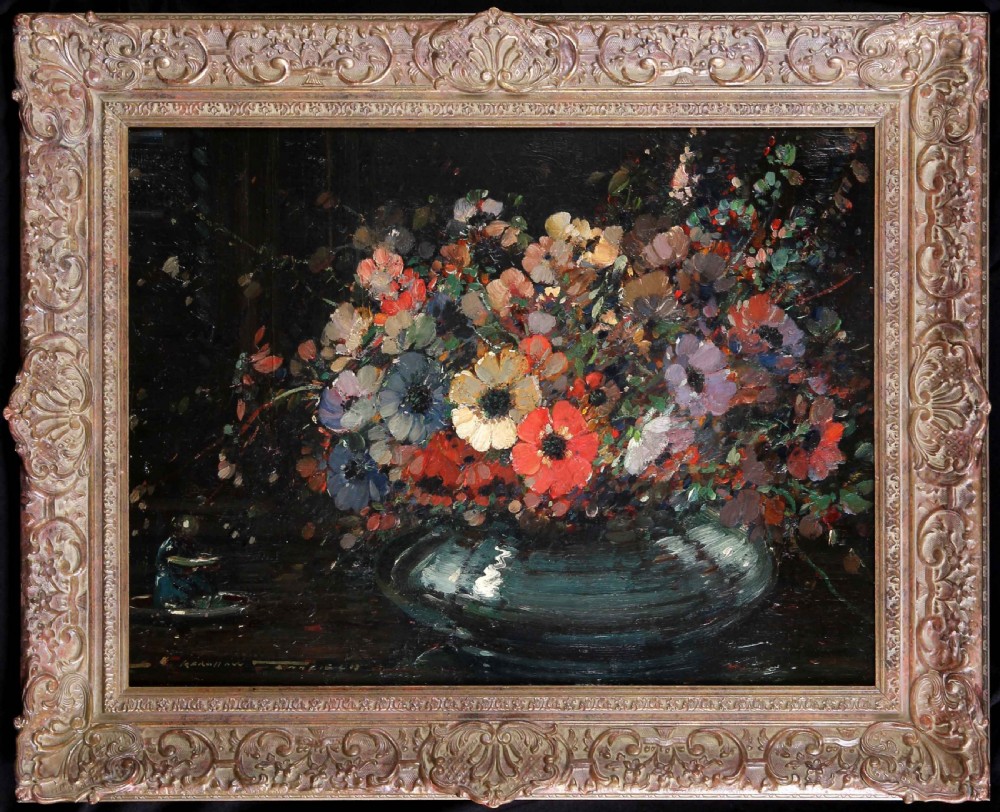 An impressionistic oil painting depicting a colourful arrangement of anemone flowers in a dark vase, presented inside an ornate carved gilded frame.