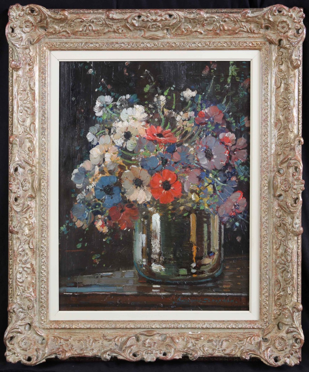 An impressionist oil painting depicting a vase filled with colourful anemones set inside an ornate carved swept gilt frame.
