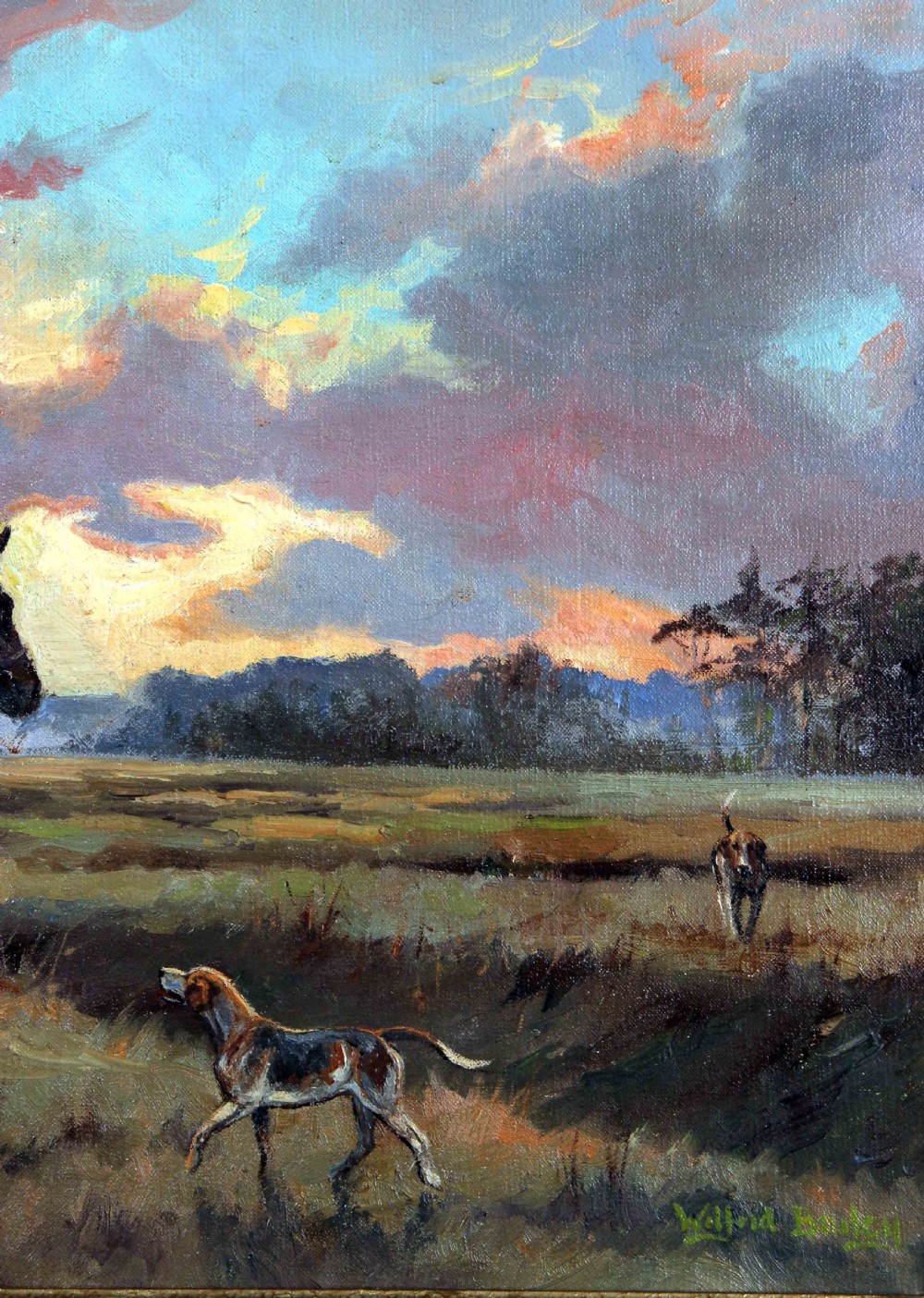 An antique oil painting depicting a huntsman in a scarlet coat on a bay horse surrounded by hounds in an open landscape under a dramatic sky. View VI