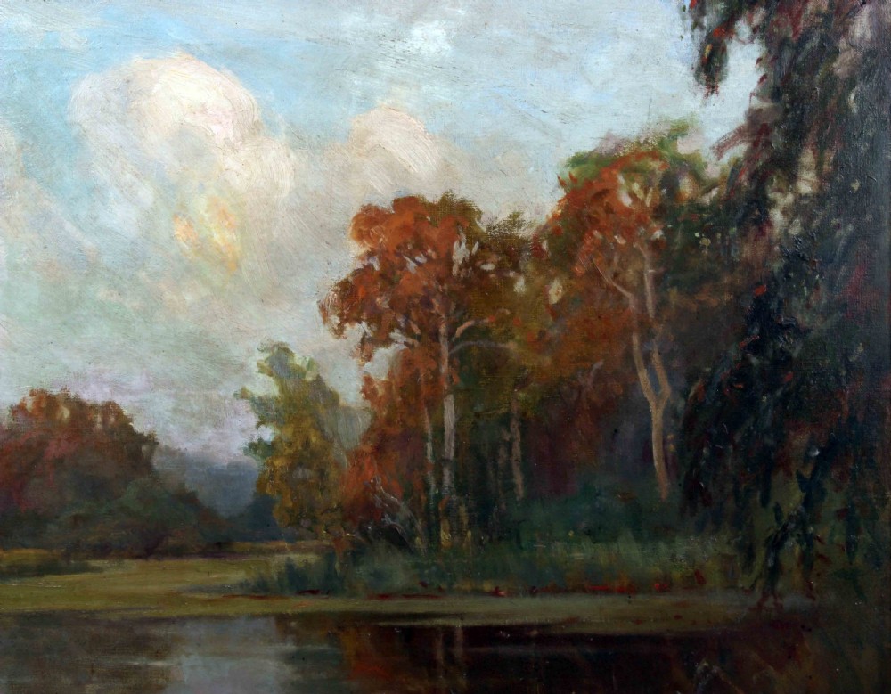 A framed oil painting depicting an autumnal lake landscape with orange trees and reflections on dark water, set within an ornate gilded frame. View IV